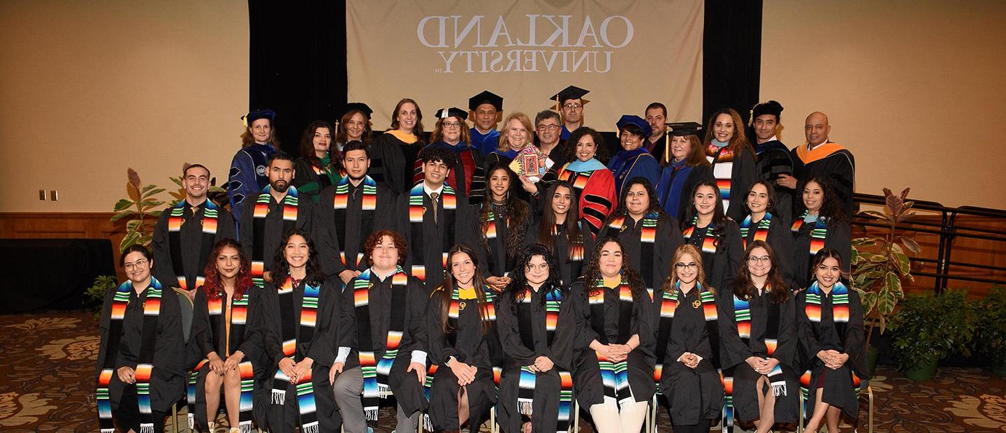 Group of students in graduation gowns at Latina/o/x graduation ceremony