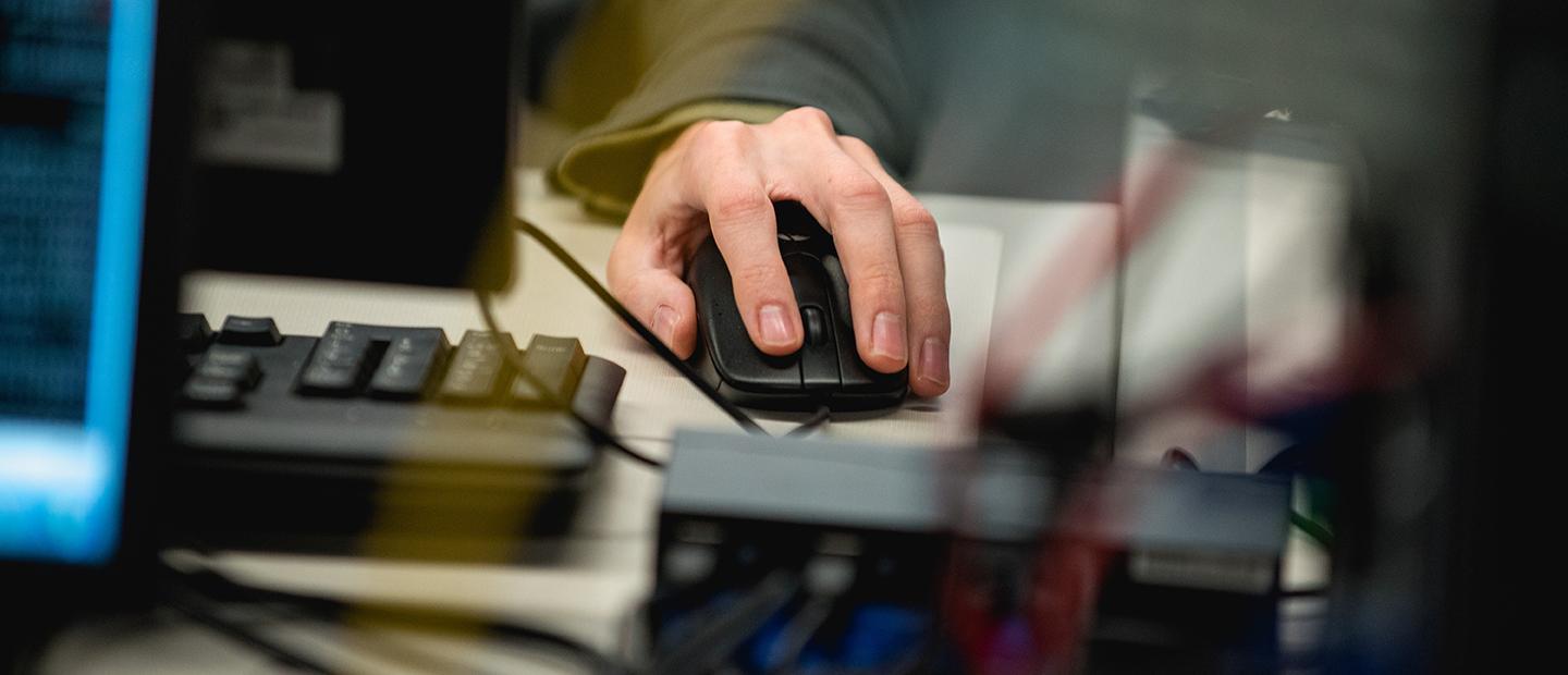 A hand using a computer mouse